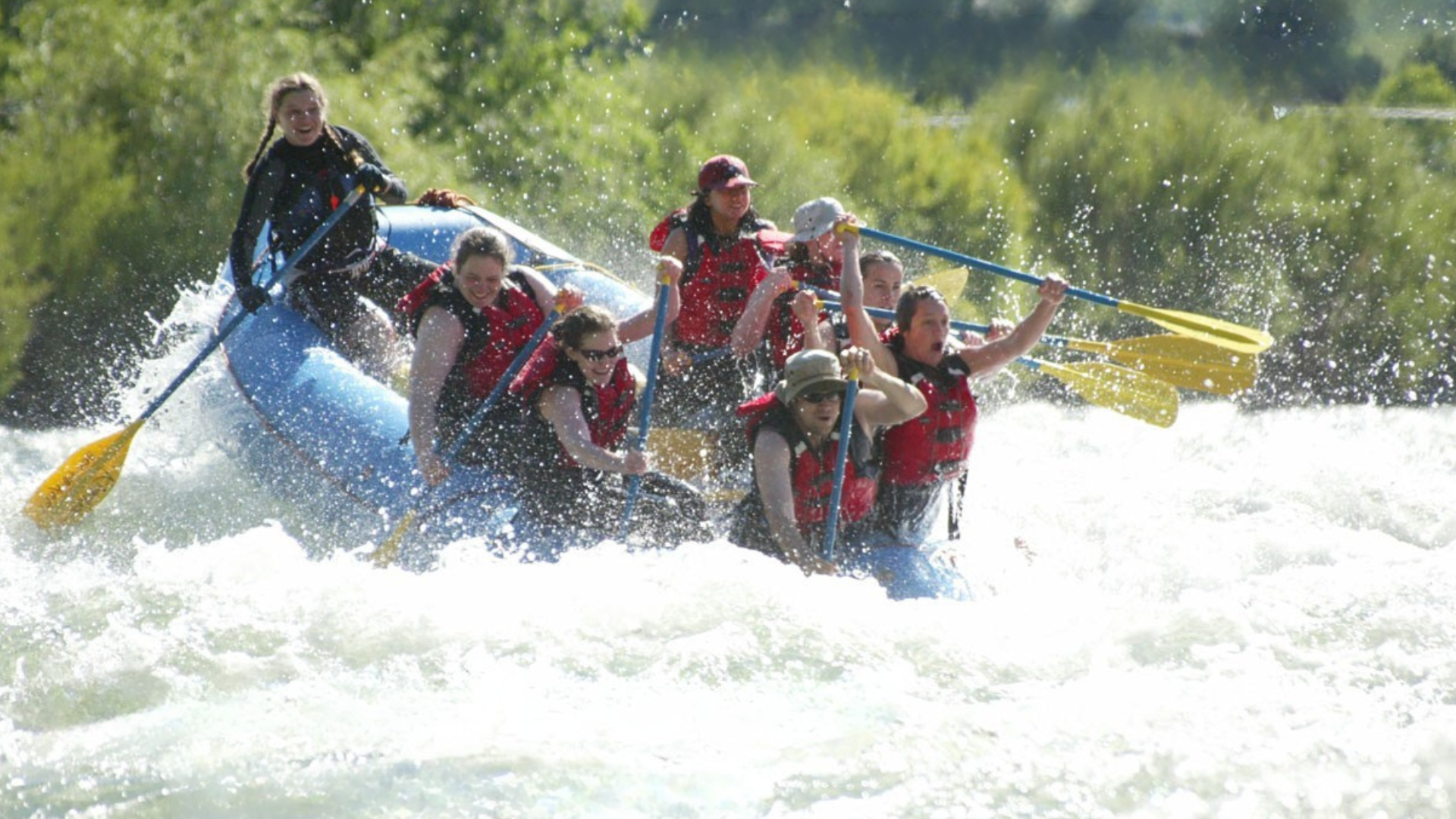 A group of people are rafting down a river.