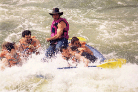 A group of people are riding a raft down a river.