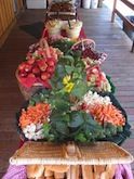A long table topped with a variety of fruits and vegetables.