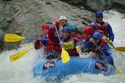 A group of people are rafting down a river