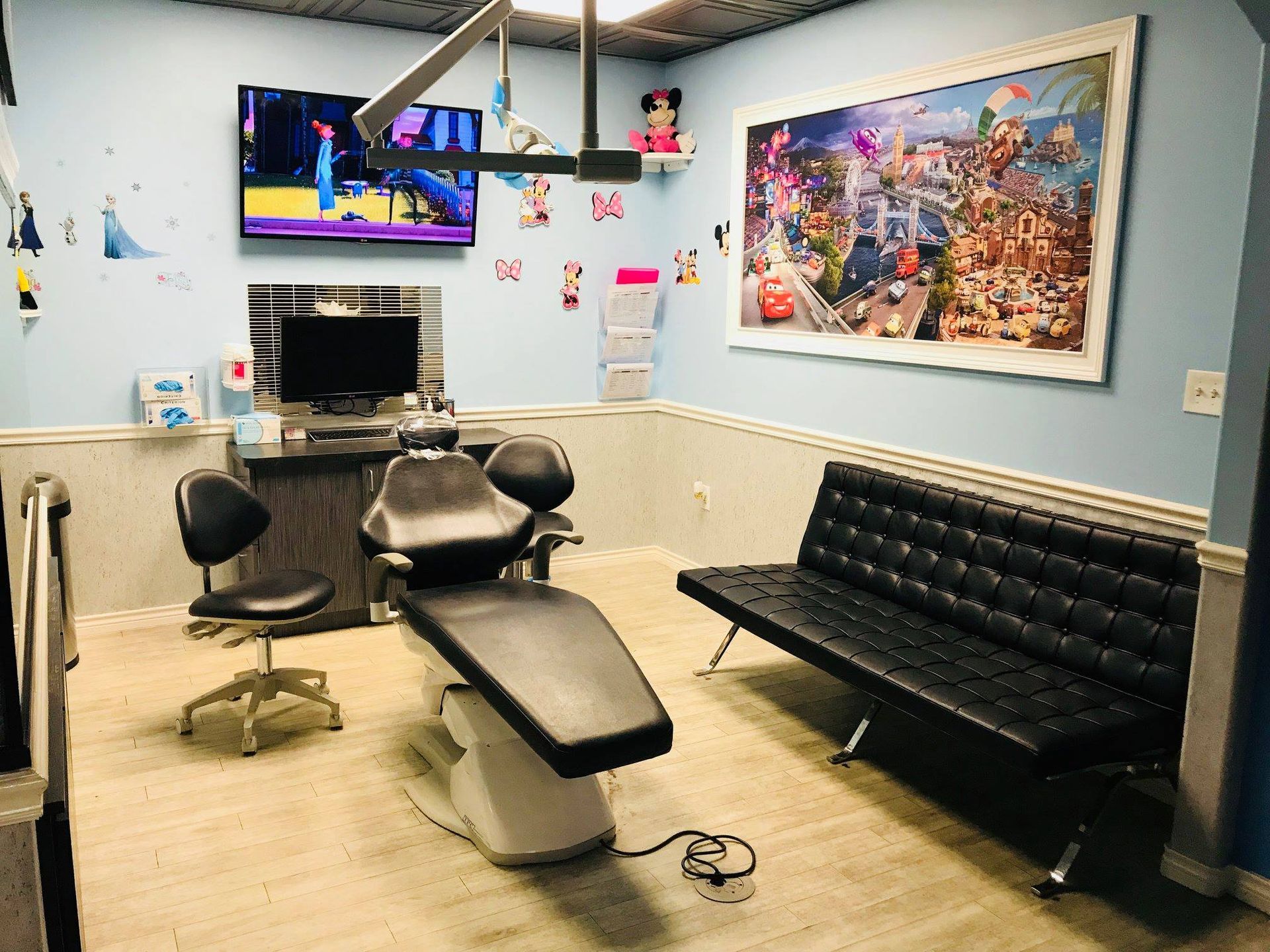 Modern tattoo parlor with chairs, treatment table, couch, and colorful wall art