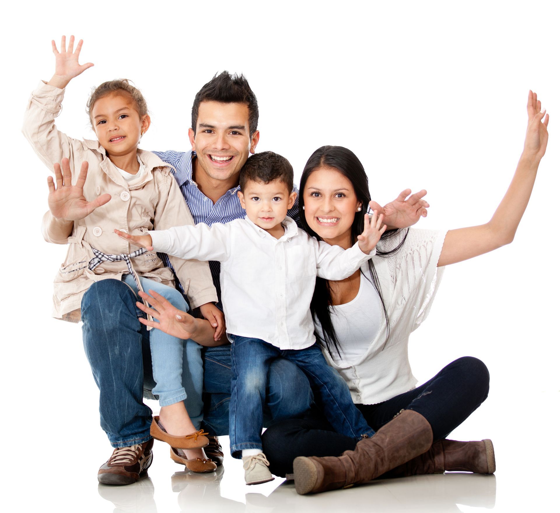 Smiling family of four posing together on a white studio background
