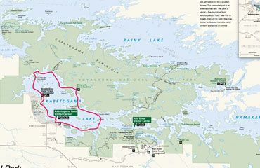 A map of Voyageurs National Park showing Rainy, Kabetogama, and Namakan lakes with visitor center locations and borders.