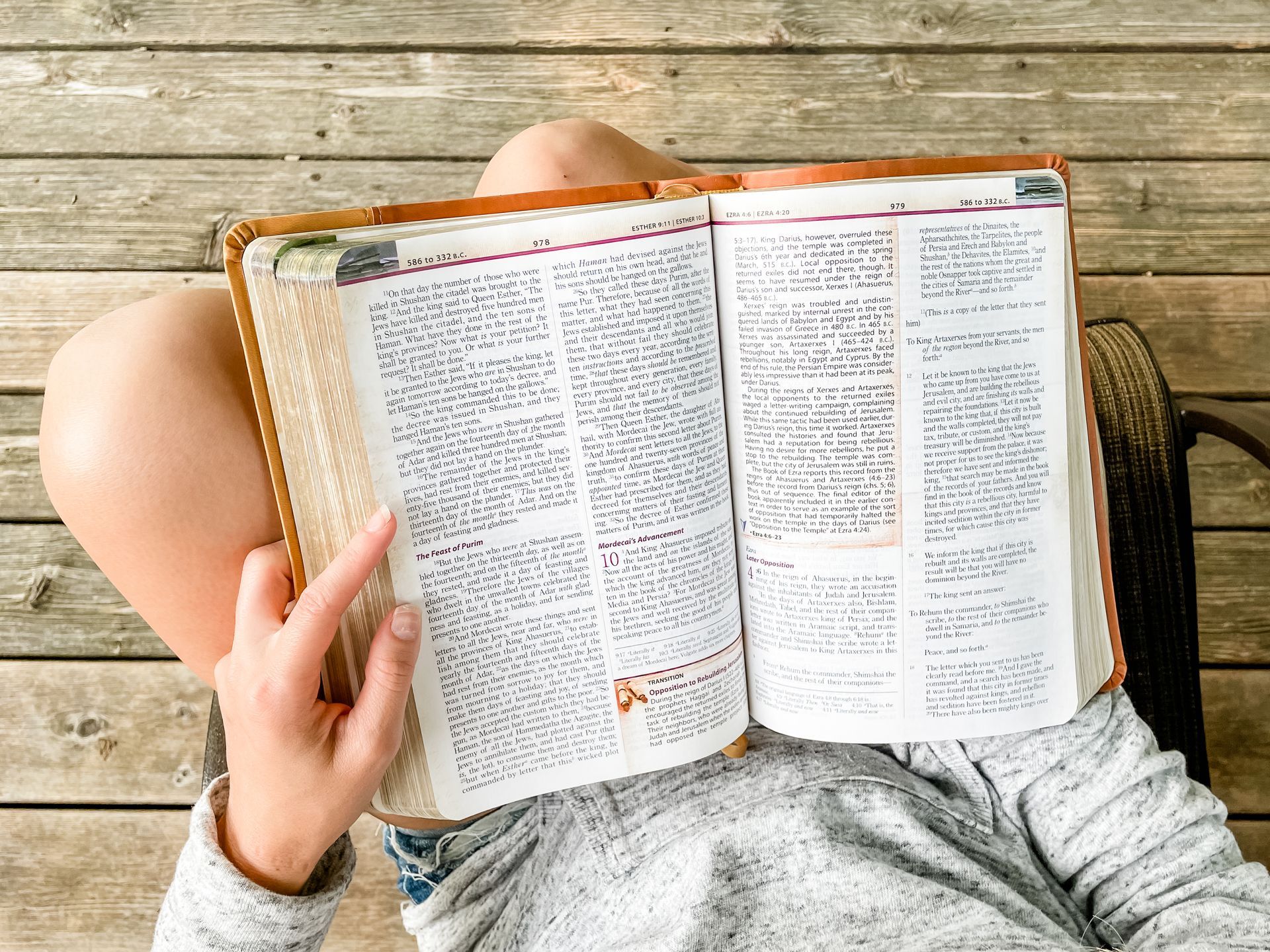 Bible with a woman sitting in a chair