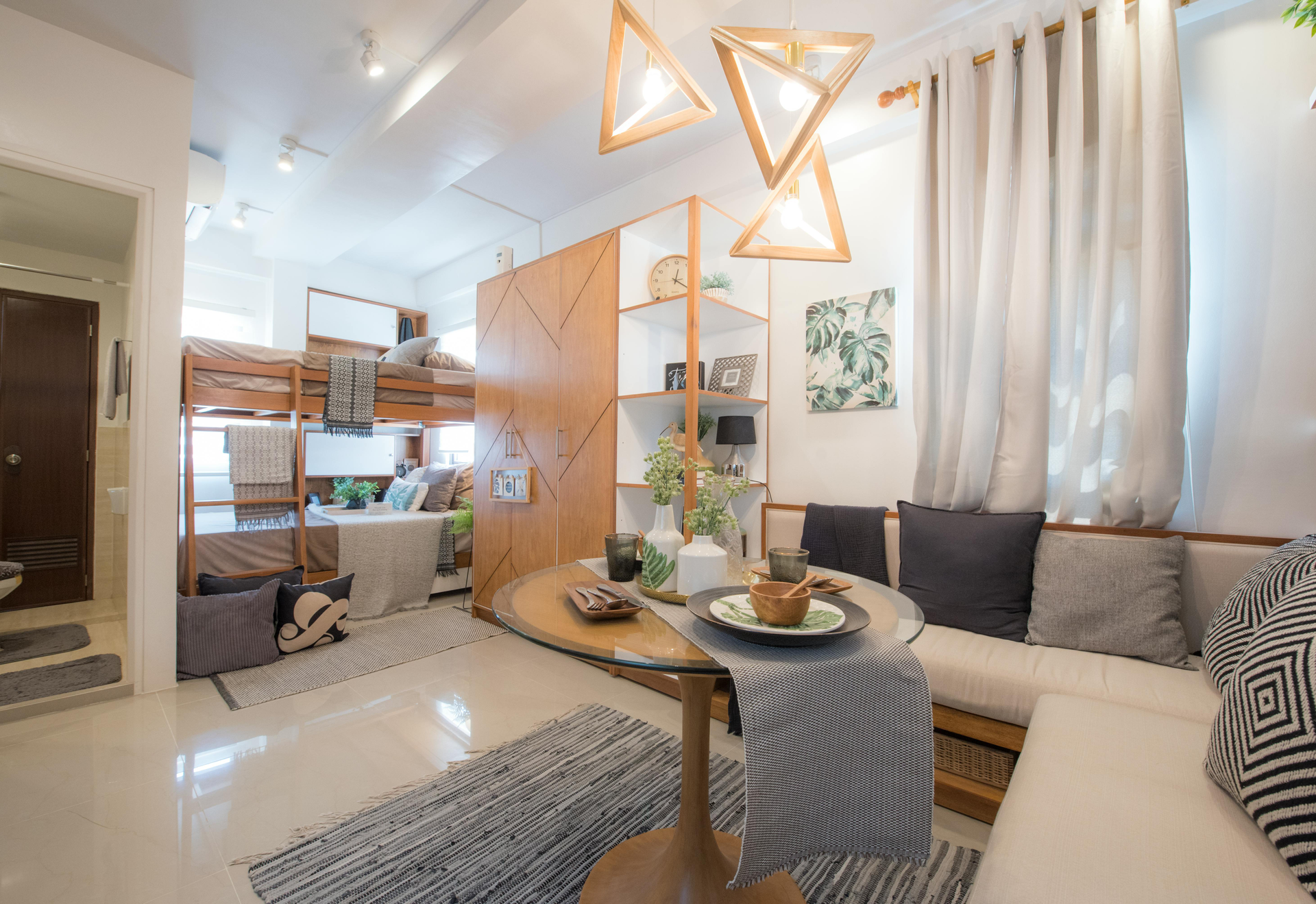Cozy studio apartment with loft bed, dining area, and neutral tones.