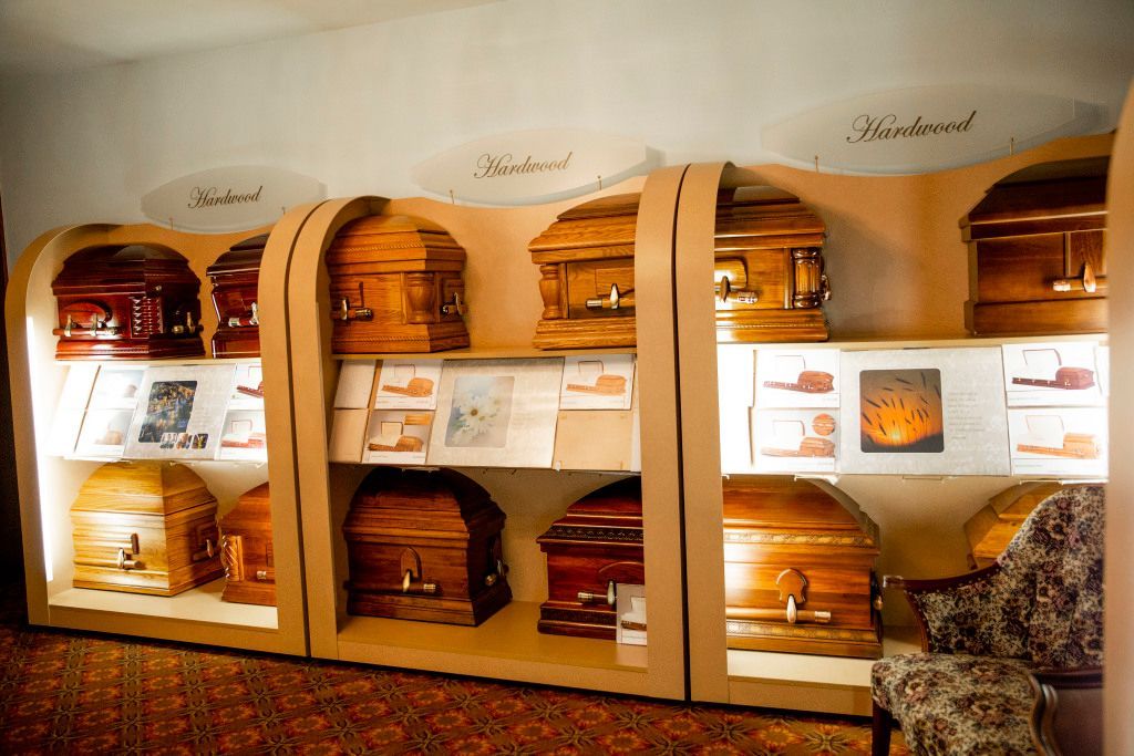 A room filled with lots of coffins and a chair