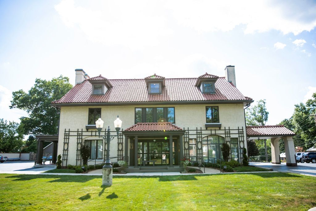 A large white house with a red tile roof