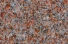 A close up of a red granite counter top.