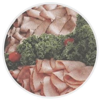 Sliced ham and lettuce in a white circle