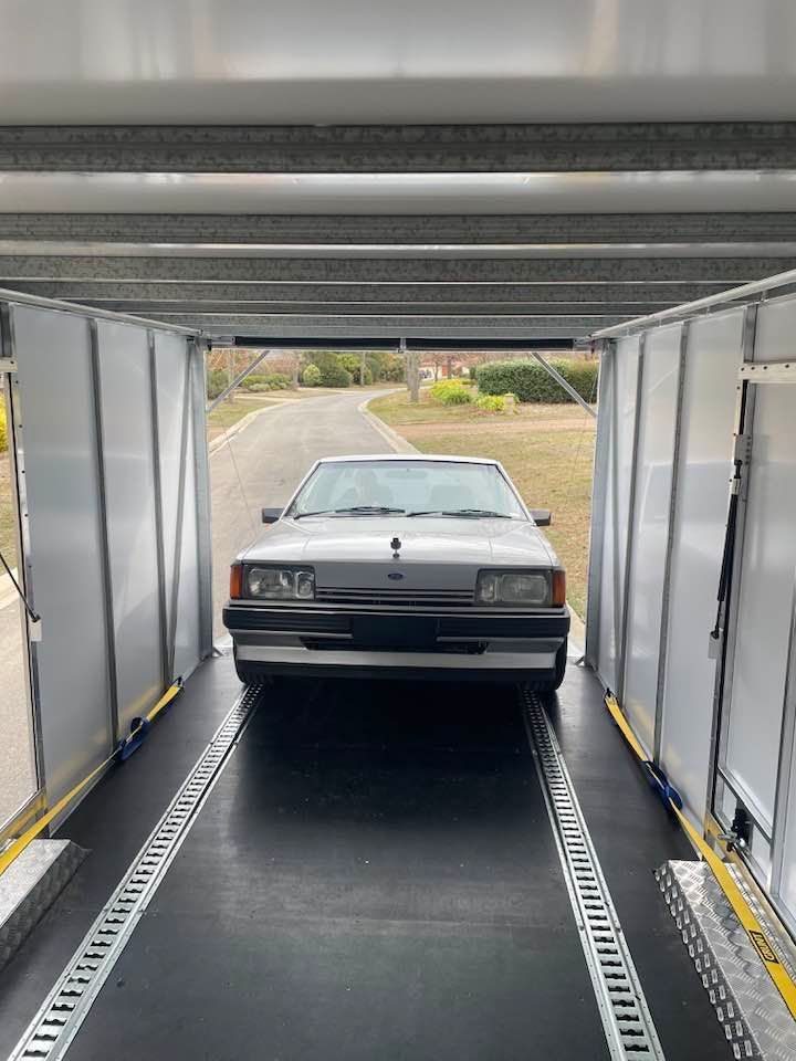Classic Silver Car Inside a Car Hauler, Ready for Transport — Full Throttle Enclosed Car Transport in Gold Coast, QLD