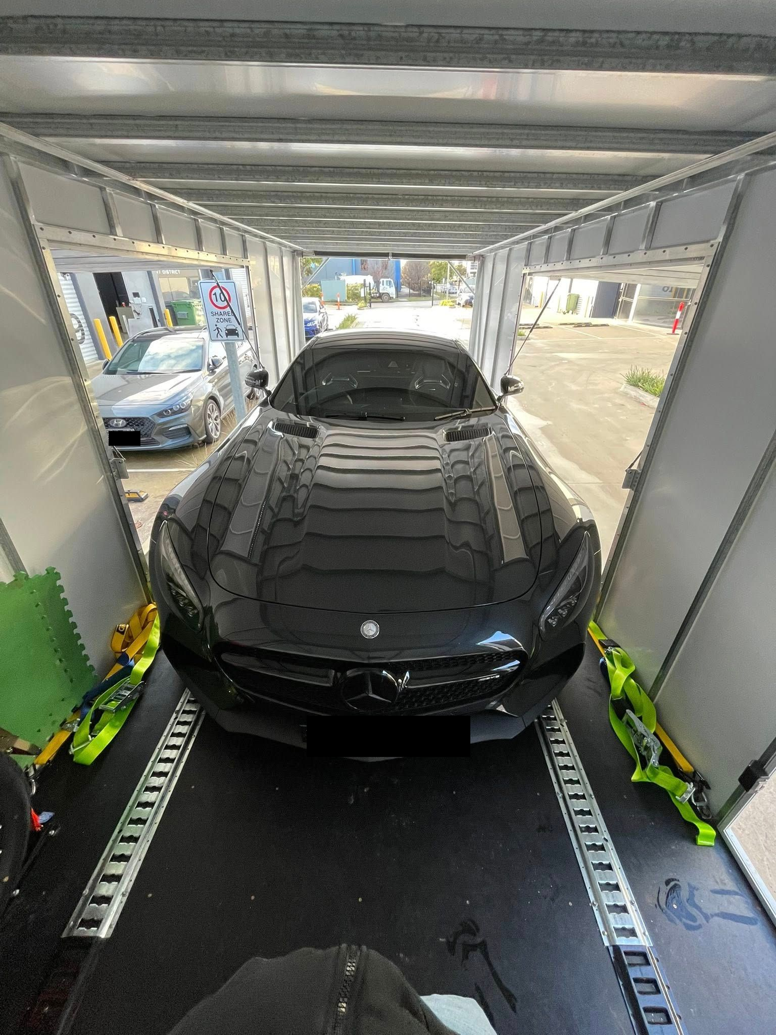 Black Mercedes sports car inside a car carrier — Full Throttle Enclosed Car Transport in Kilmore, VIC