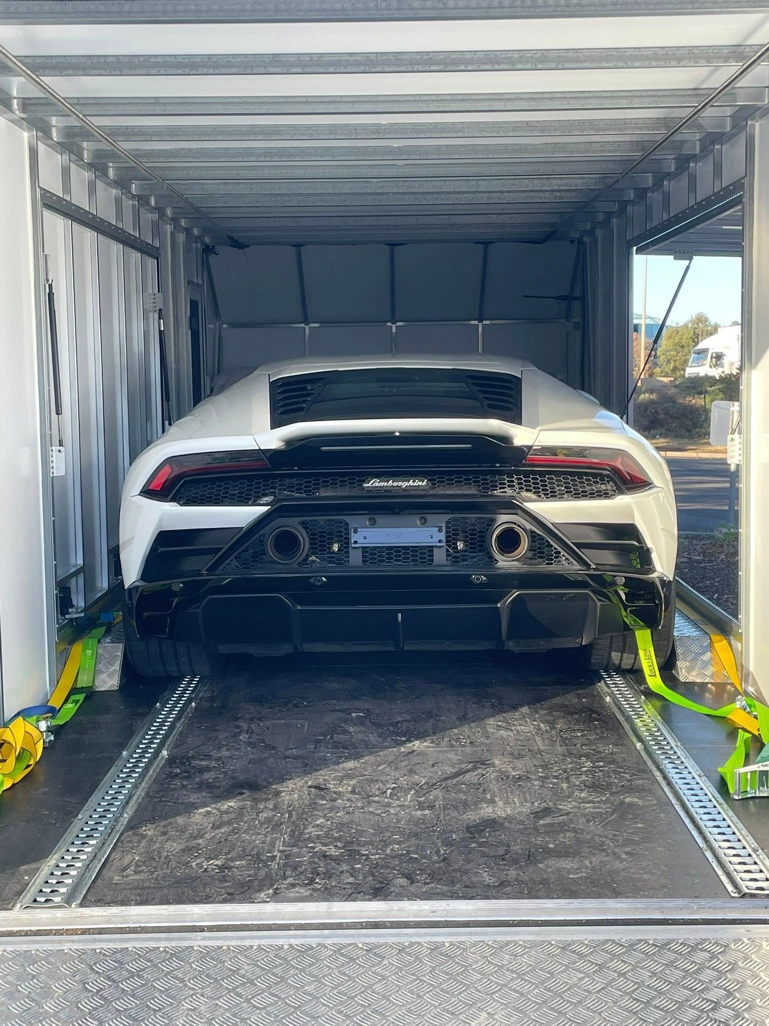 White Lamborghini secured in an enclosed car hauler, ready for transport — Full Throttle Enclosed Car Transport in Kilmore, VIC