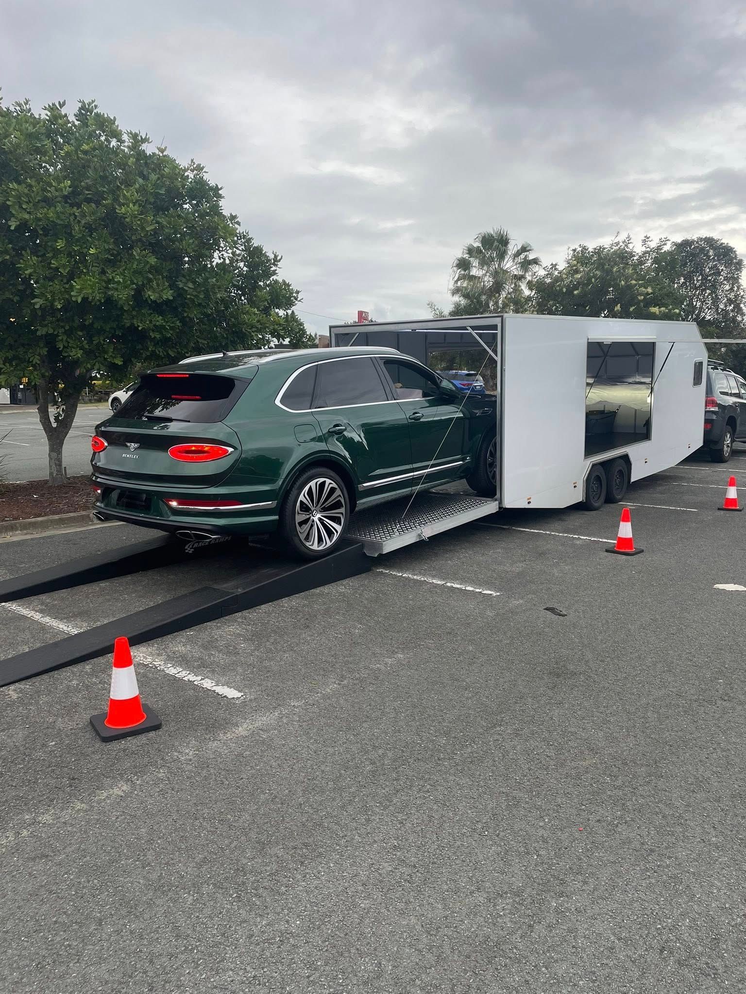 Green Bentley SUV being loaded onto a white enclosed trailer — Full Throttle Enclosed Car Transport in Kilmore, VIC