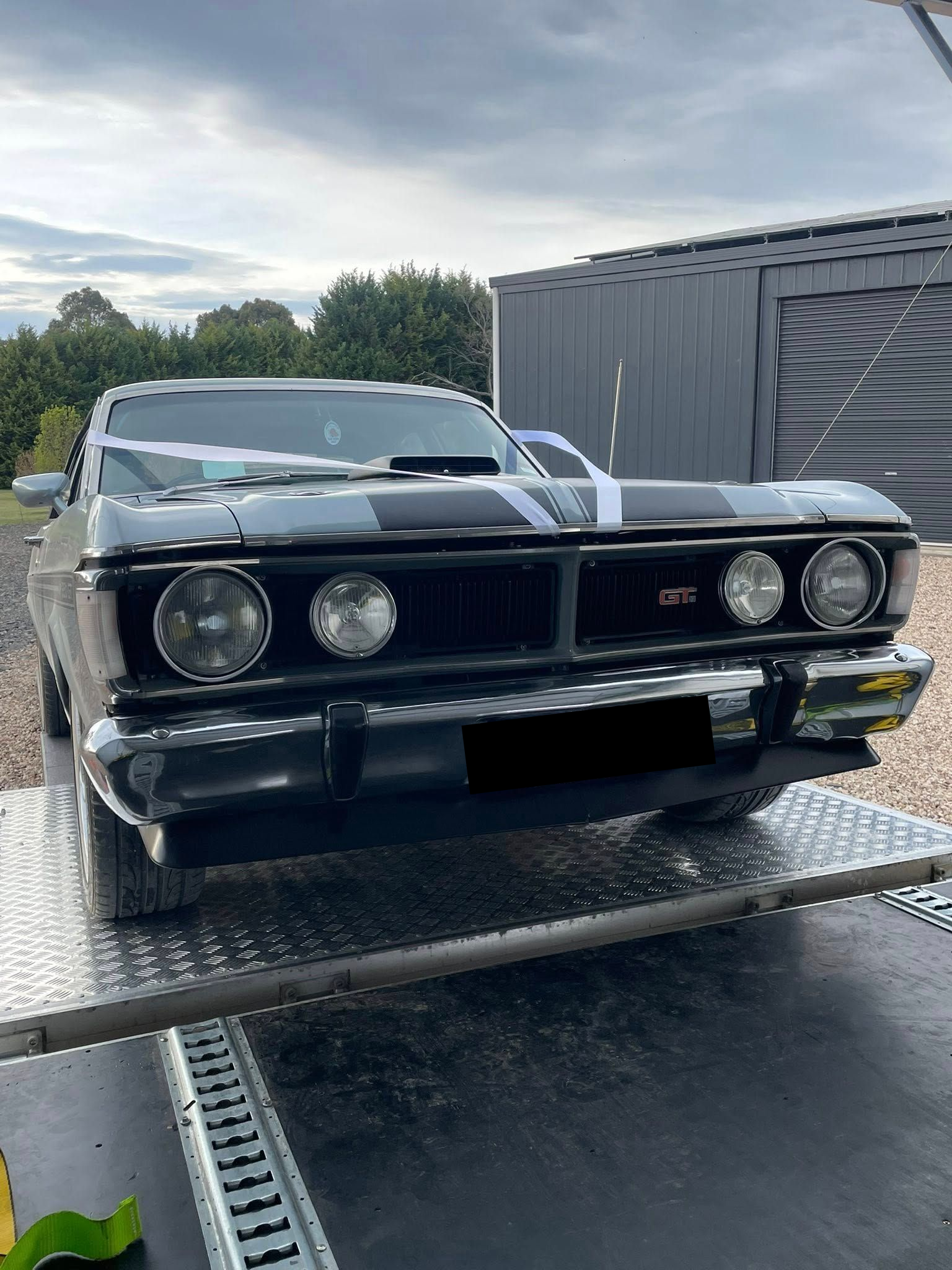Black Classic Car with Racing Stripes on A Metal Trailer — Full Throttle Enclosed Car Transport in Sunshine Coast, QLD