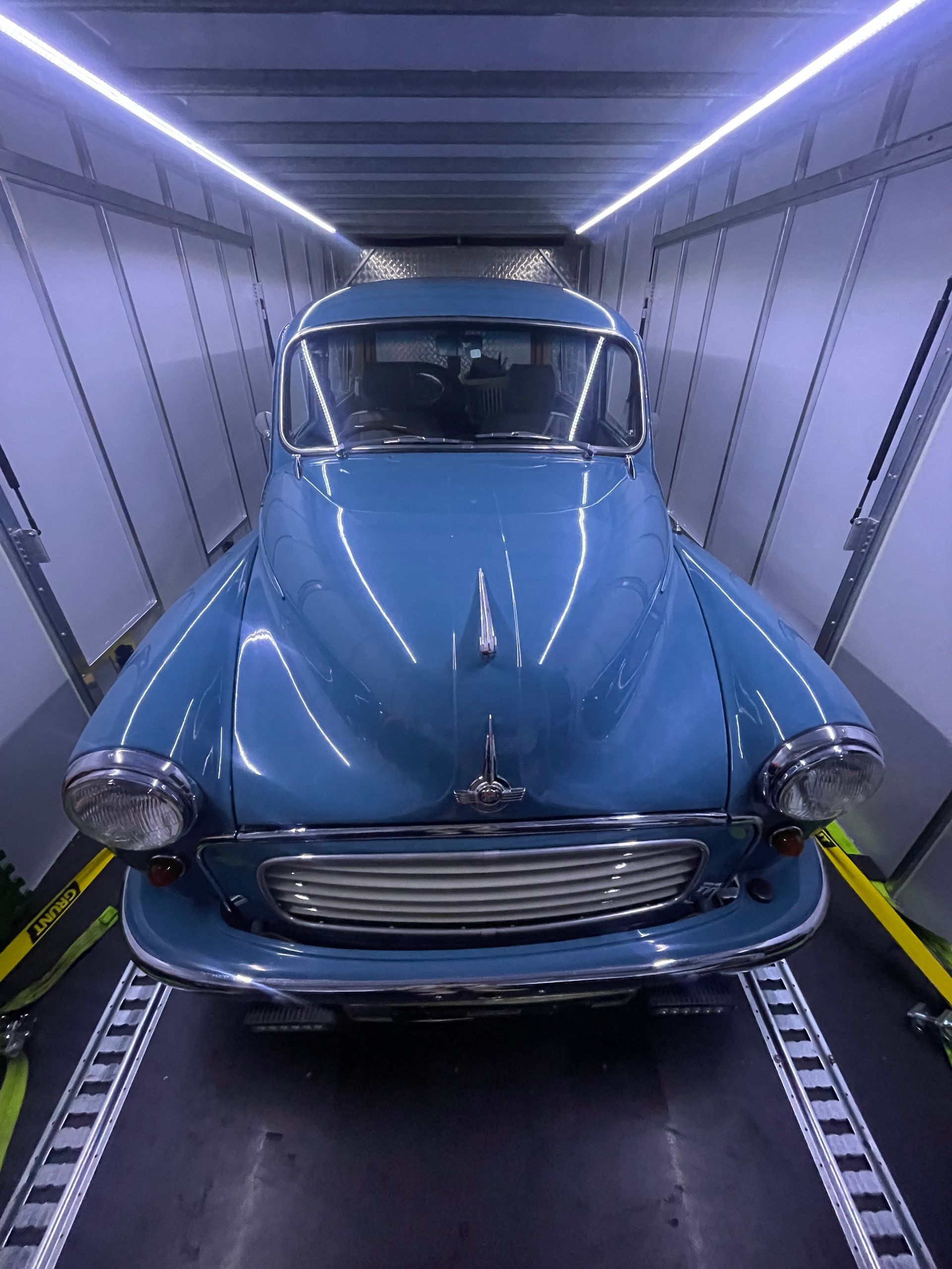 Blue vintage car inside a transport trailer with illuminated walls -Full Throttle Enclosed Car Transport in Kilmore, VIC
