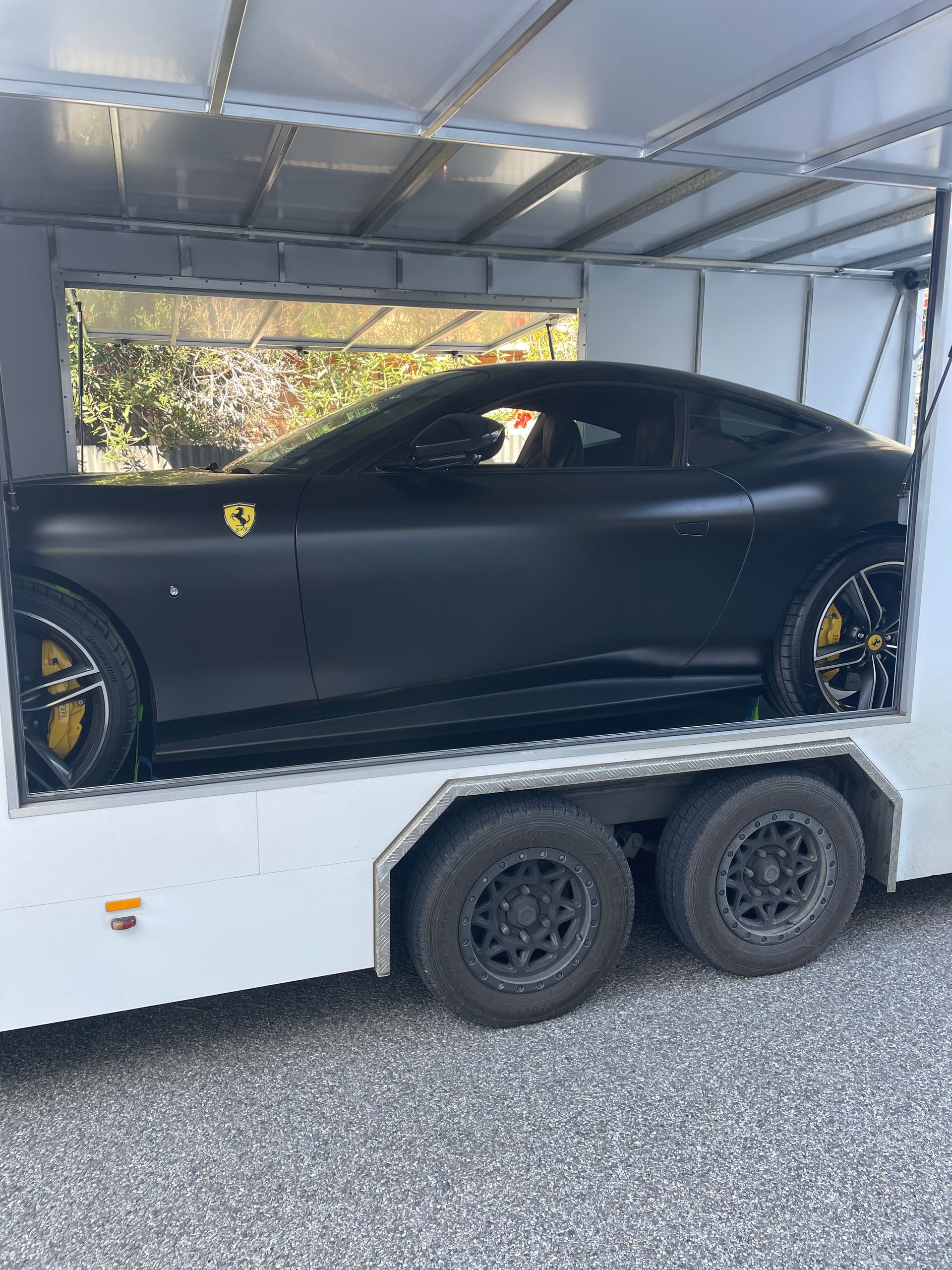 Black Ferrari inside a white enclosed trailer — Full Throttle Enclosed Car Transport in Kilmore, VIC
