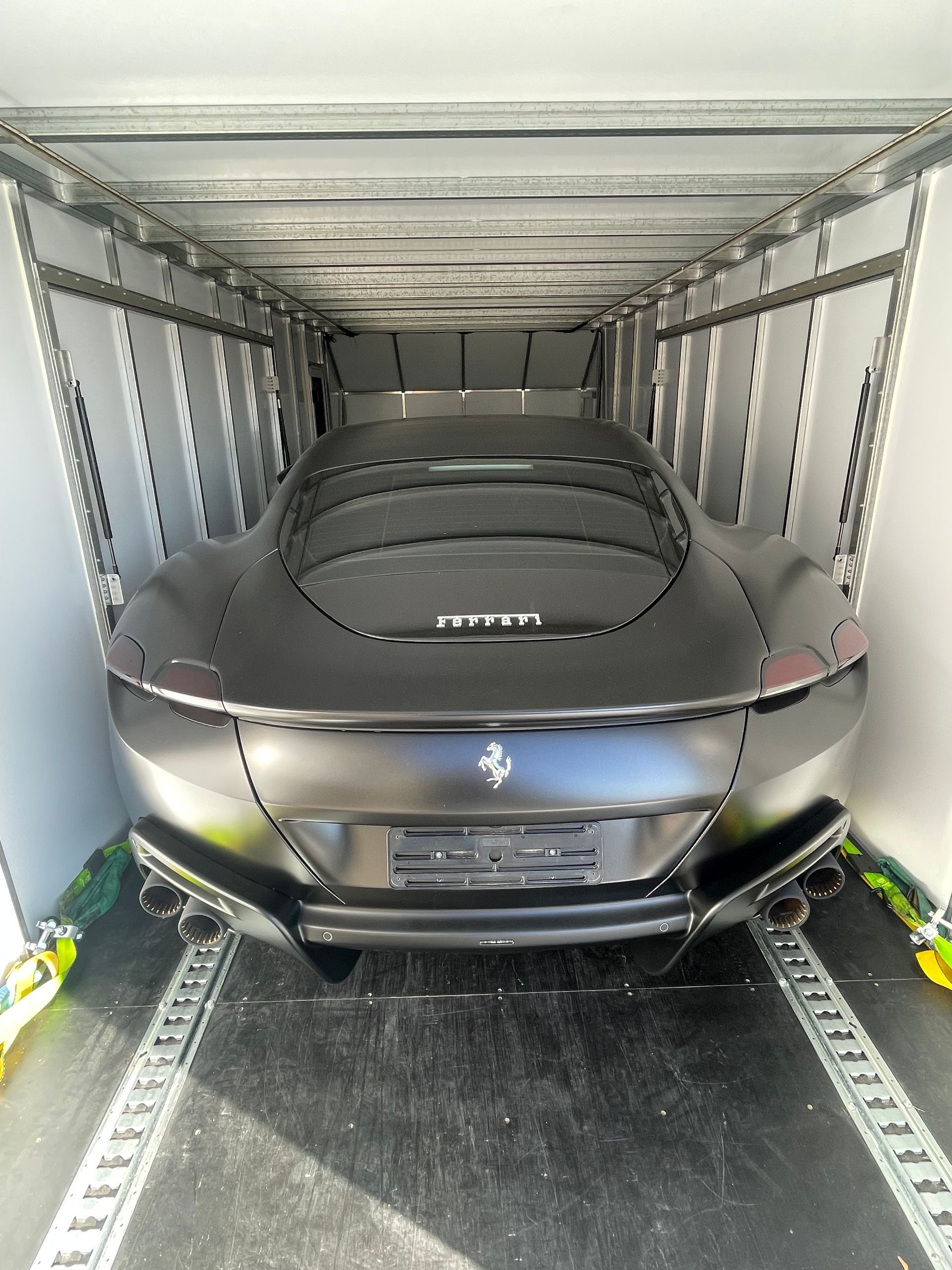 Black Ferrari sports car inside a transport truck — Full Throttle Enclosed Car Transport in Kilmore, VIC