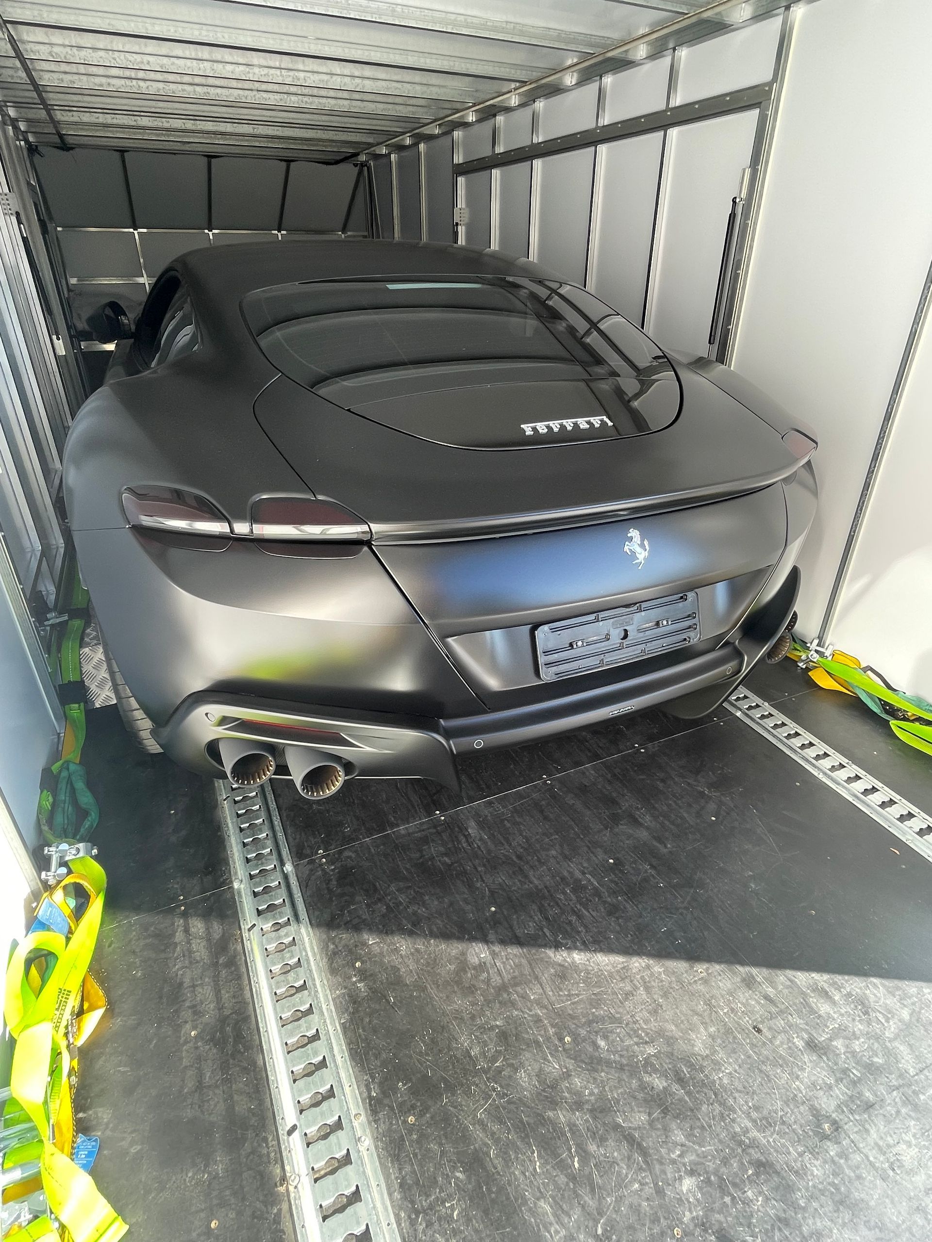 Black Ferrari Roma sports car secured inside a trailer for transport — Full Throttle Enclosed Car Transport in Kilmore, VIC