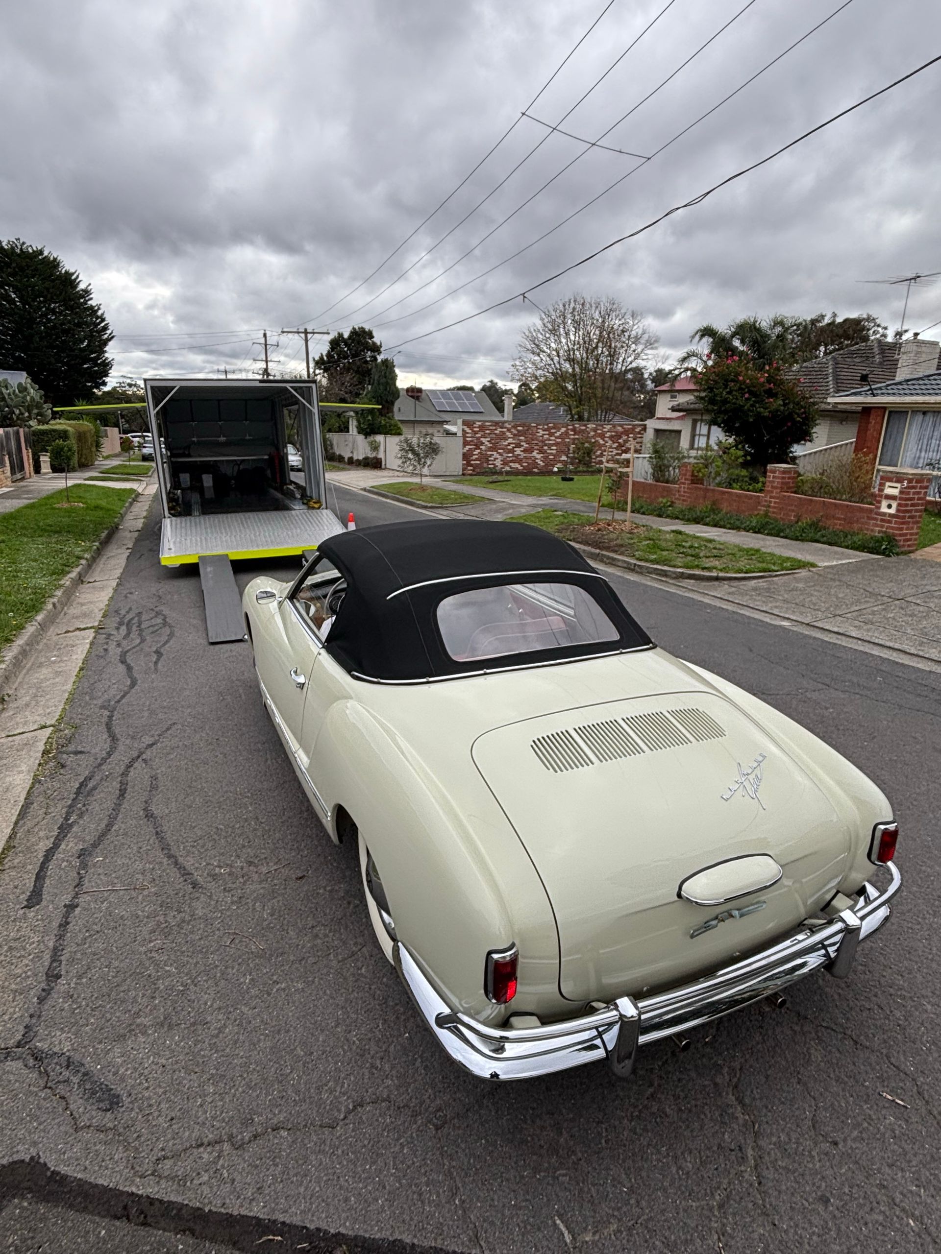 Vintage cream convertible on a residential street behind a tow truck. - Full Throttle Enclosed Car Transport in Kilmore, VIC