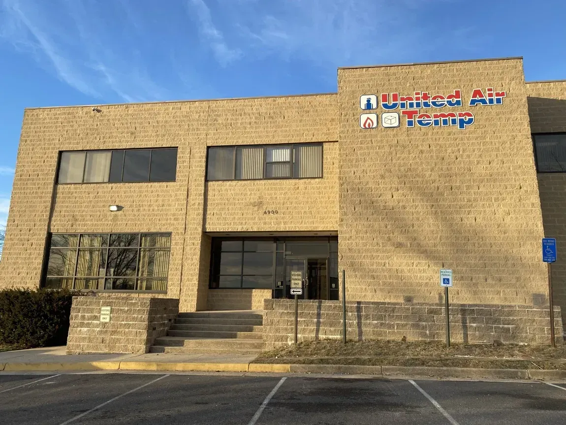 A large brick building with a parking lot in front of it.