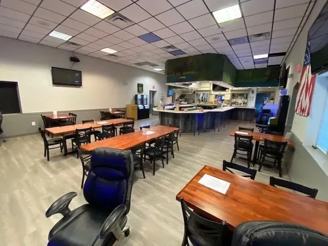 A large room with tables and chairs in it.