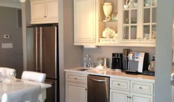 A kitchen with white cabinets and stainless steel appliances.