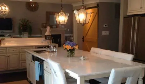 A kitchen with a table and chairs and a sliding barn door.