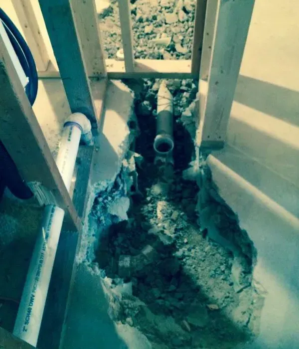A hole in the ground with a pipe coming out of it.