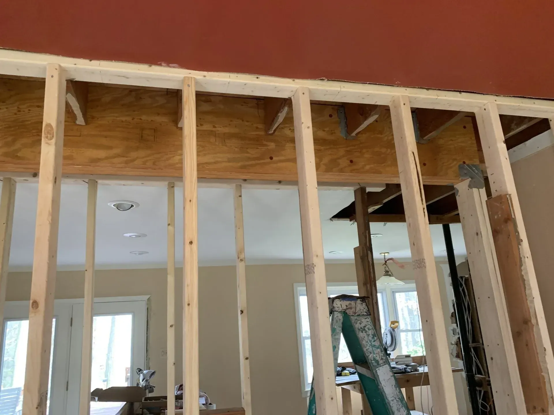 A wooden frame is being built in a living room.