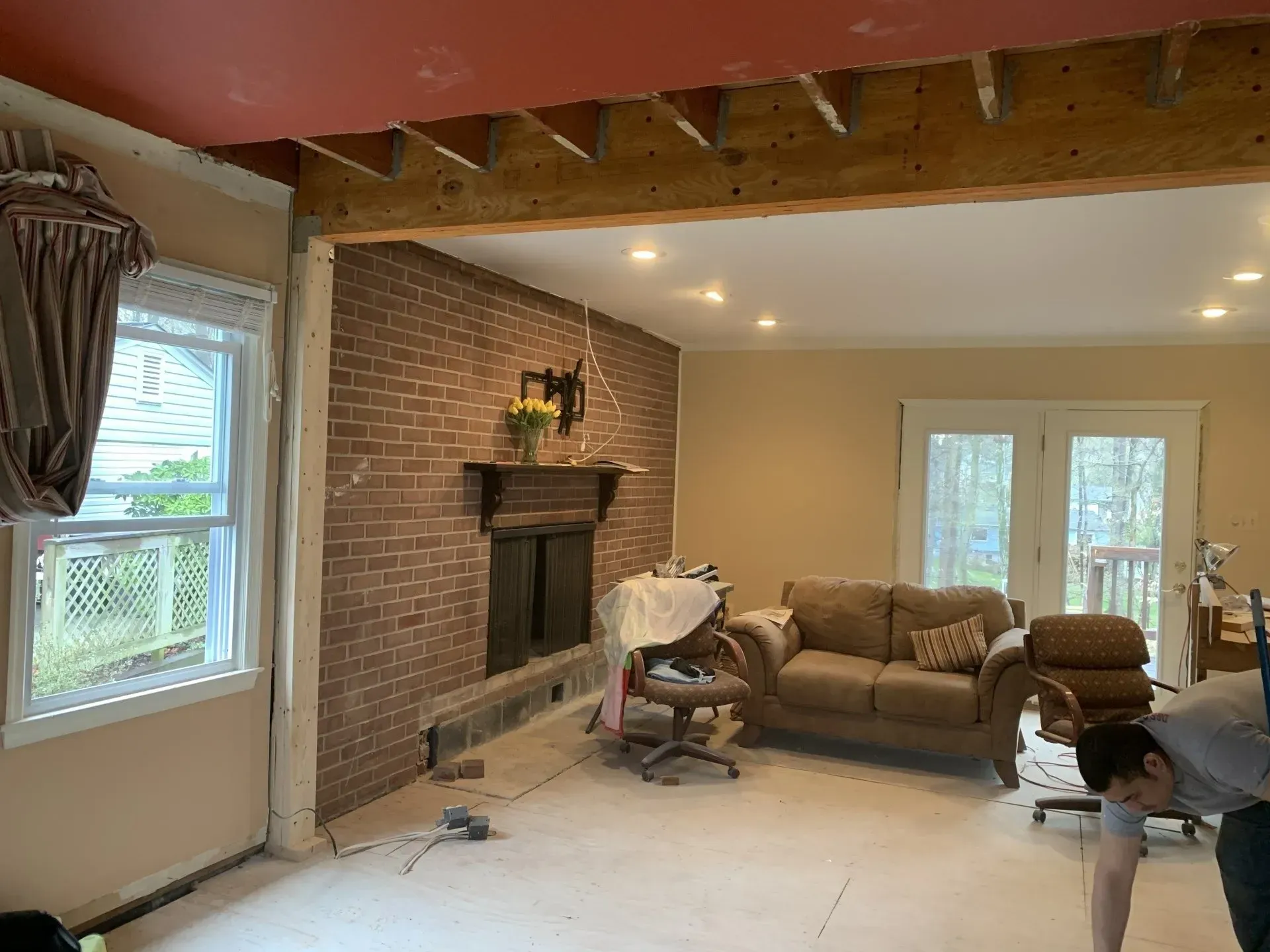 A living room with a couch , chair and fireplace.