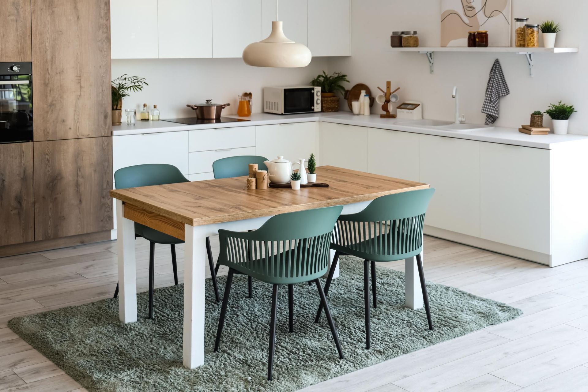 A kitchen with a table and chairs in it.
