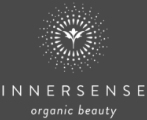 Innersense Organic Beauty logo with a stylized white leaf-and-sun symbol on a dark background