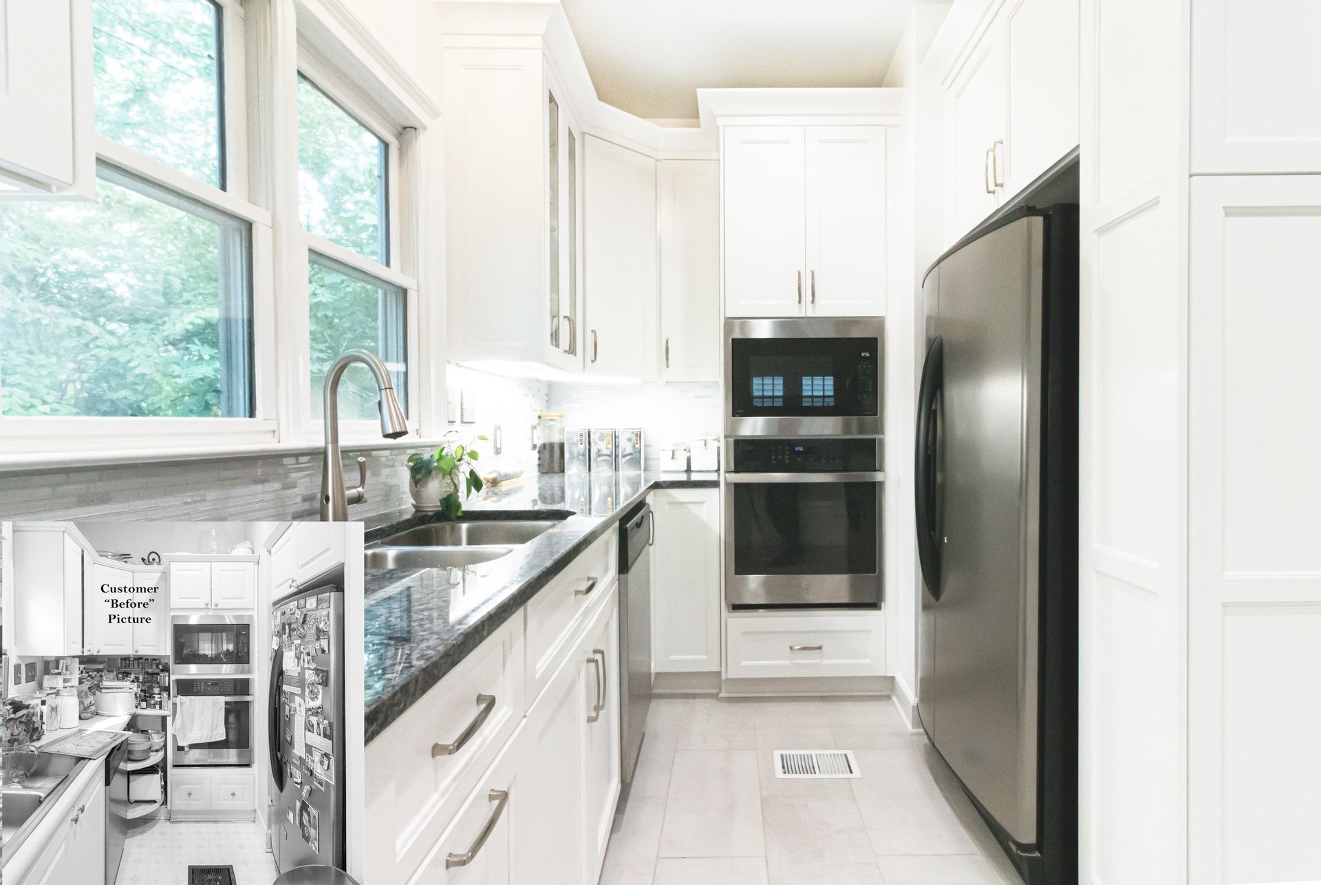 Bright narrow kitchen with white cabinets, stainless appliances, and a large window over the sink.