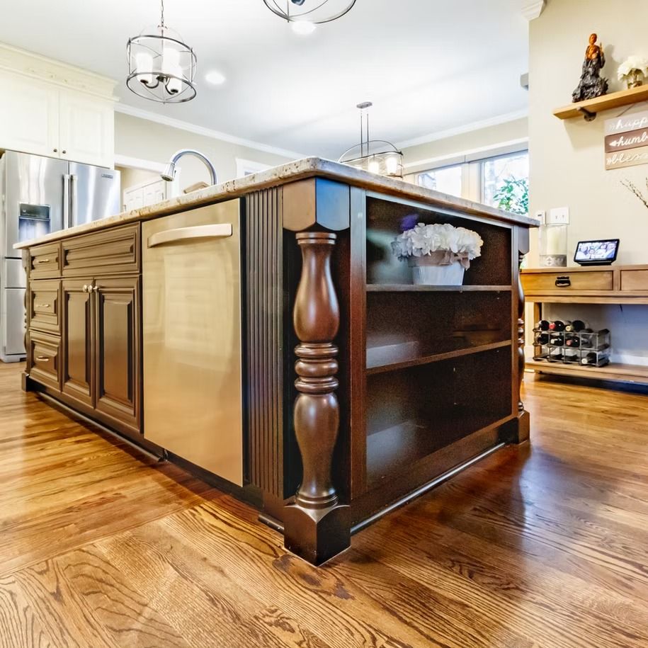 Large dark wood kitchen island with stools in a bright modern kitchen