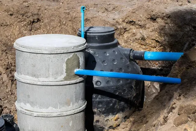 A Septic Tank is Sitting in the Dirt in a Trench — Edwards Plumbing Pty Ltd in Kingscliff, NSW