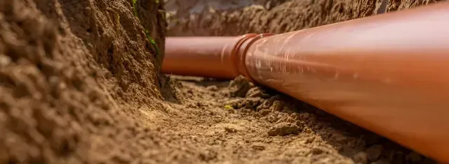 A Pipe is Being Installed in a Hole in the Ground — Edwards Plumbing Pty Ltd in Tweed Heads, NSW