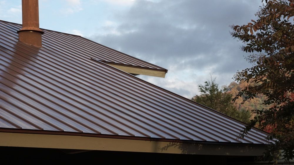 A Brown Metal Roof with A Chimney on Top of It — Edwards Plumbing Pty Ltd in Ocean Shores, NSW