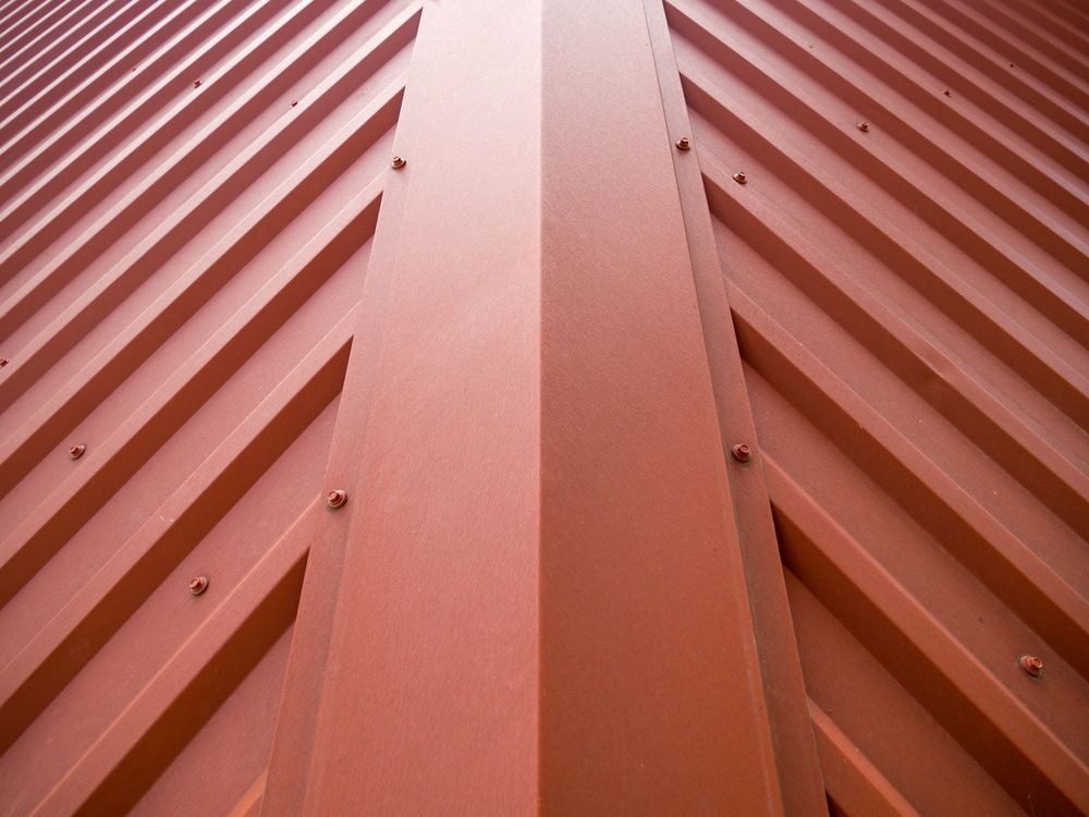 A Close up Of a Red Roof with A Diagonal Pattern — Edwards Plumbing Pty Ltd in Pottsville, NSW