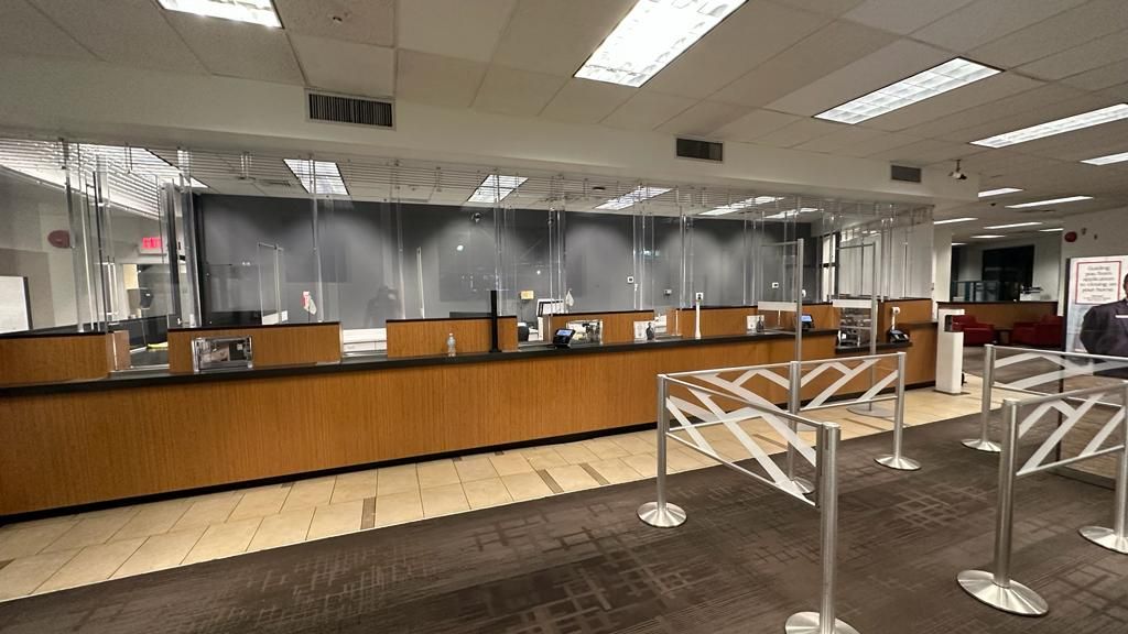 A large empty room with a counter and barriers