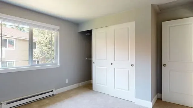 Bedroom with closet and window.