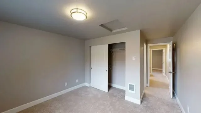 Bedroom with closet and hallway access.