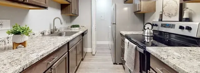 Modern kitchen with granite countertops and stainless steel appliances.