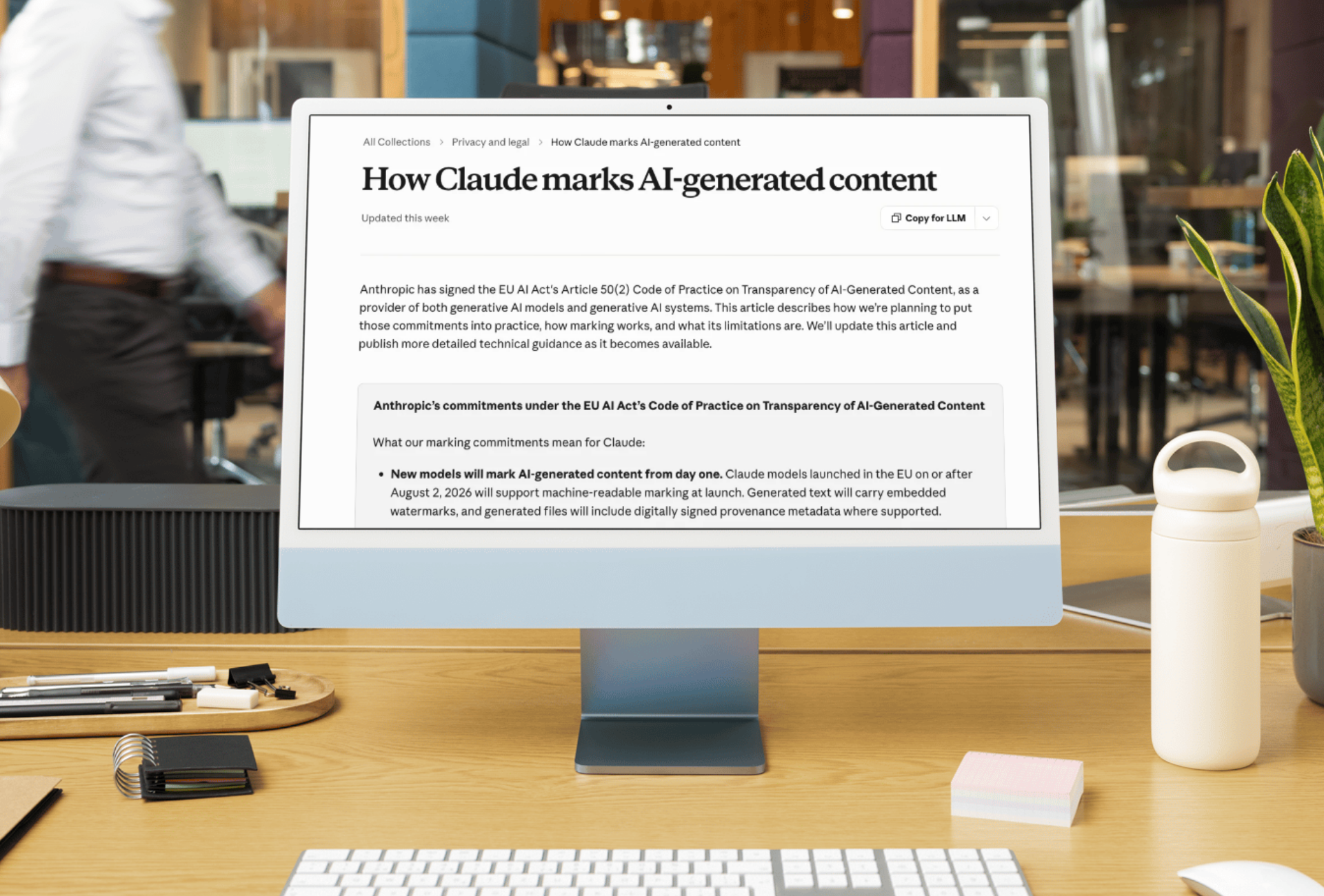 A desktop monitor displaying Anthropic's support page on how Claude marks AI generated content