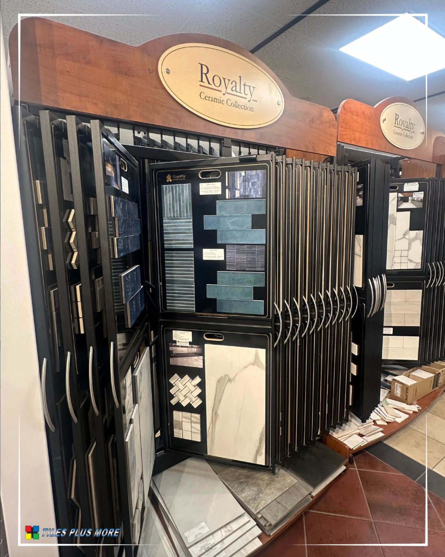 Tile showroom display with black framed sample racks and assorted tile panels