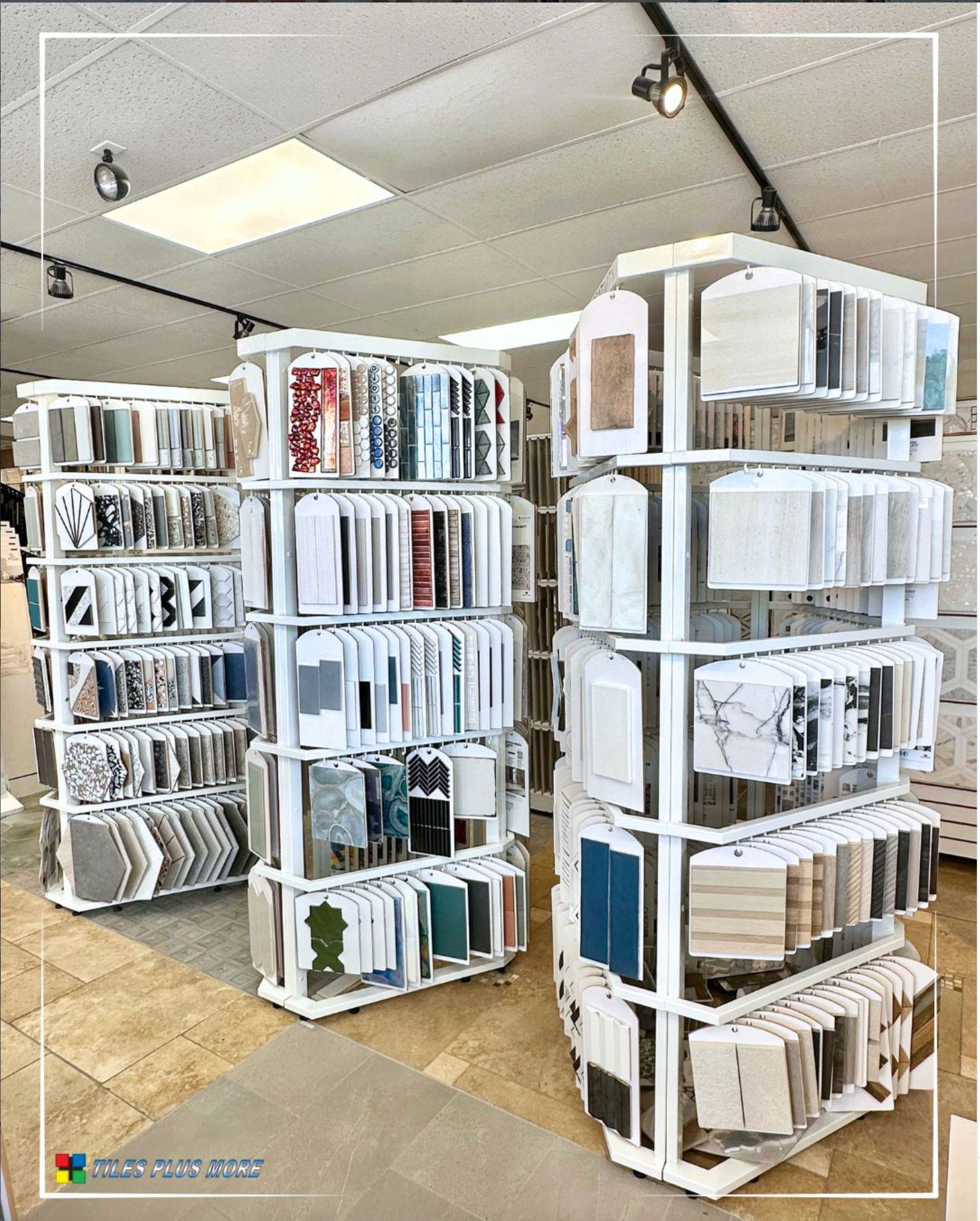 White shelving racks filled with hanging fabric swatches in a showroom or store.