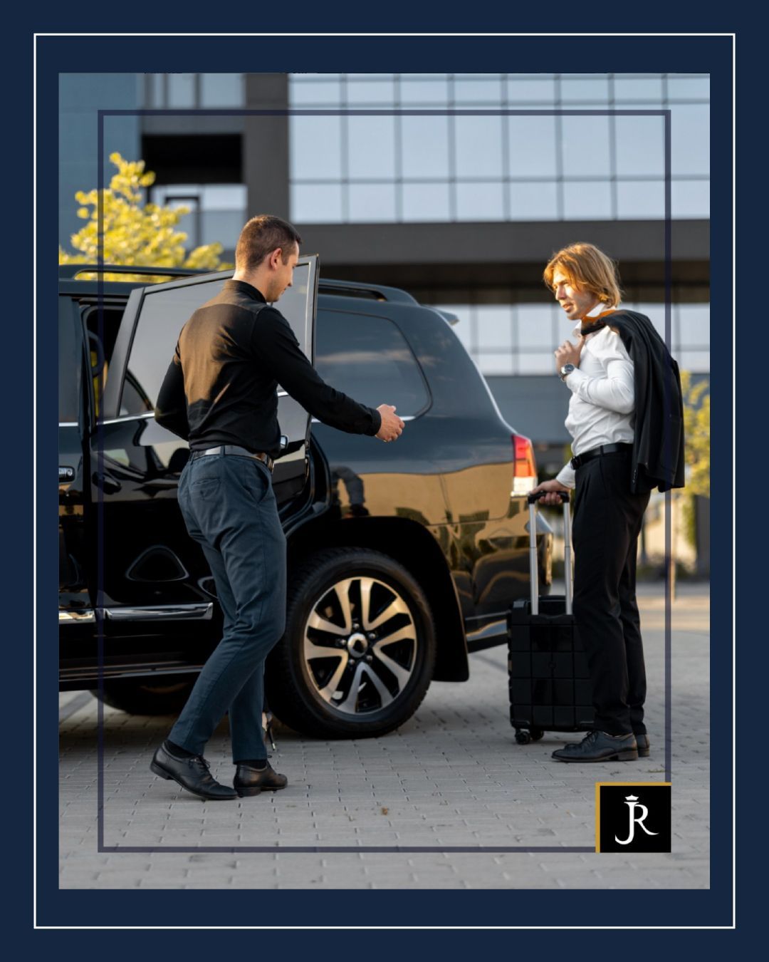 Two people by a black SUV; one loads a suitcase, with a modern building in the background.