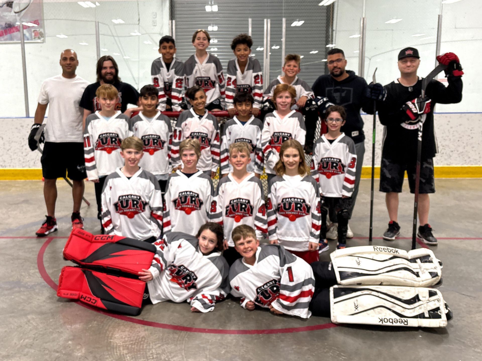 U11A Fury ball hockey team group photo wearing white jerseys