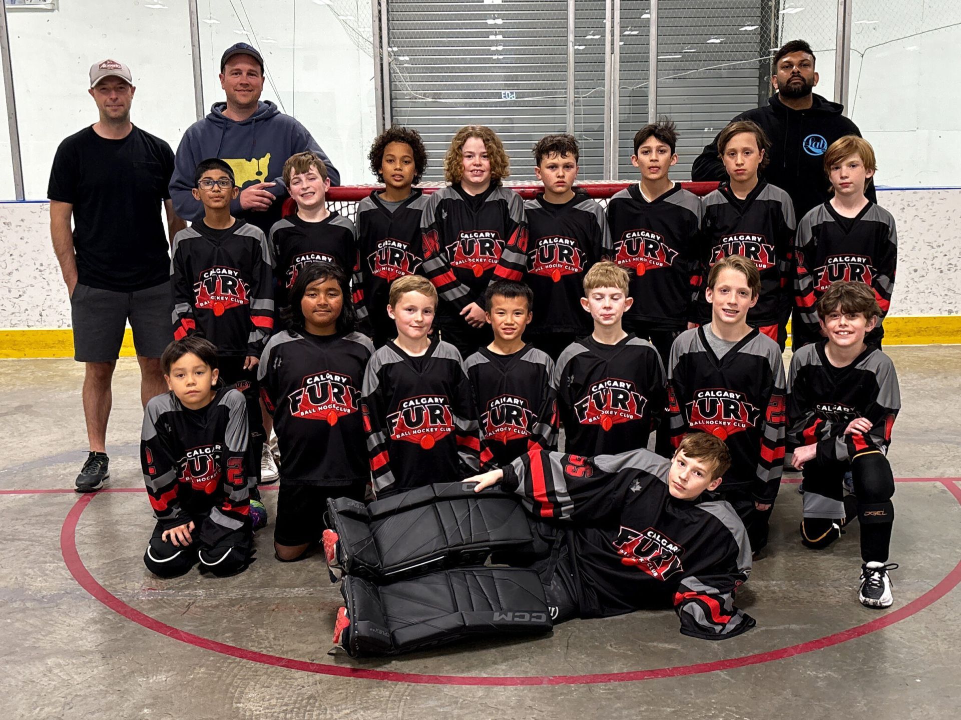 U11B Fury ball hockey team group photo wearing black jerseys