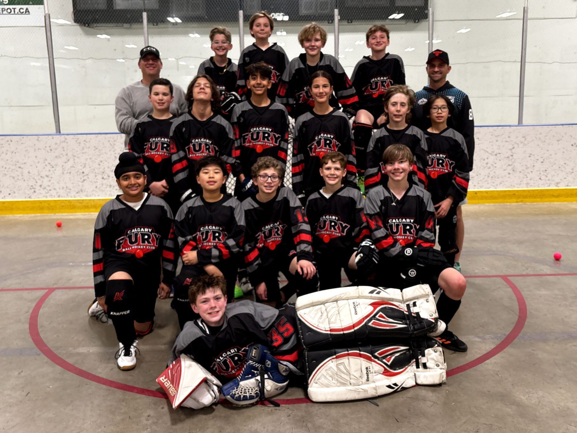 U13B Fury ball hockey team group photo wearing black jerseys