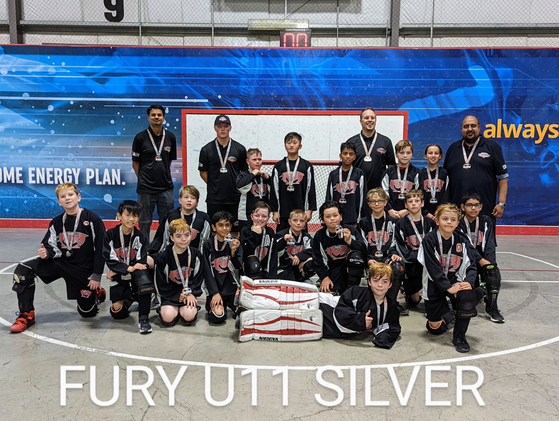 2022 U11 Fury ball hockey team group photo wearing black jerseys after winning silver